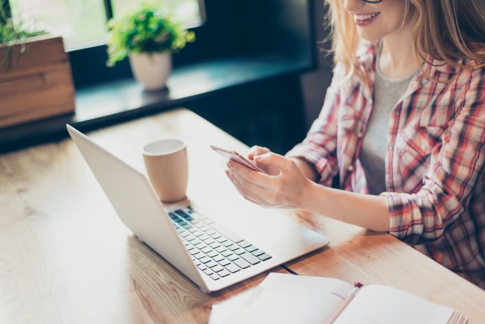 Cropped Shot Of A Young, Smiling Woman Working From Home At Her